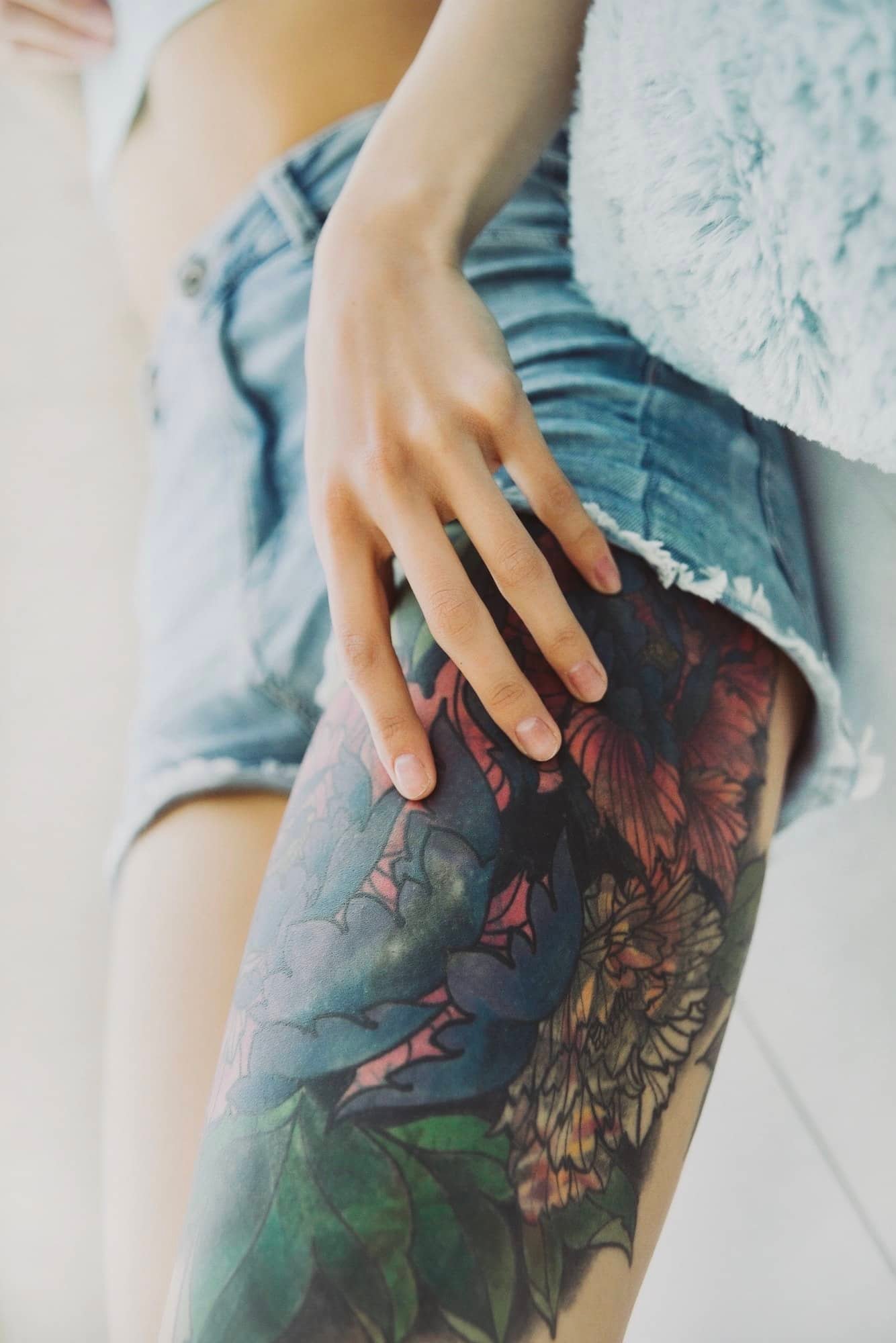 Client and tattoo artist choosing drawing for tattoo